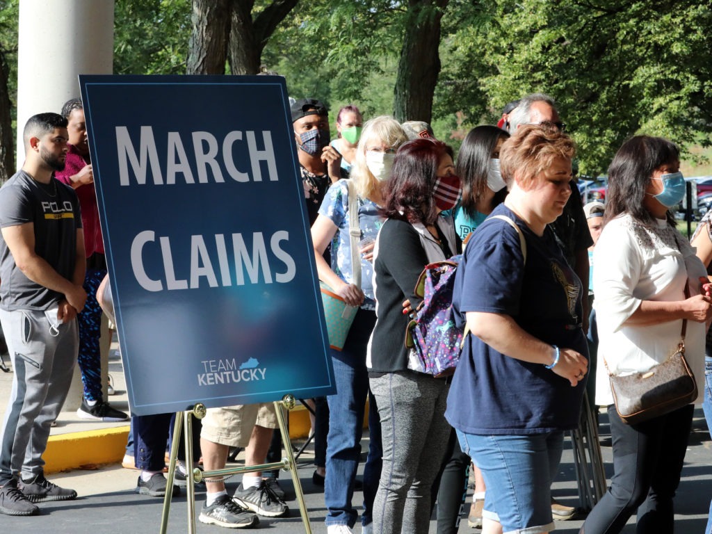 Hundreds of unemployed Kentucky residents wait in long lines outside the Kentucky Career Center in Frankfort for help with their unemployment claims on June 19. New research shows savings built up by the jobless are starting to run out. John Sommers II/Getty Images