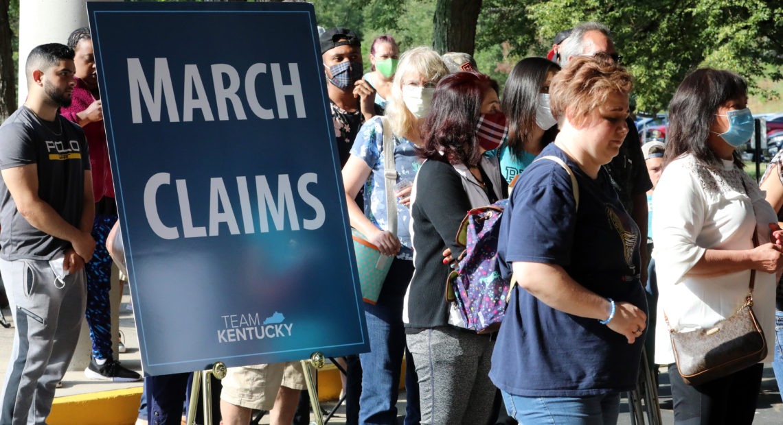 Hundreds of unemployed Kentucky residents wait in long lines outside the Kentucky Career Center in Frankfort for help with their unemployment claims on June 19. New research shows savings built up by the jobless are starting to run out. John Sommers II/Getty Images