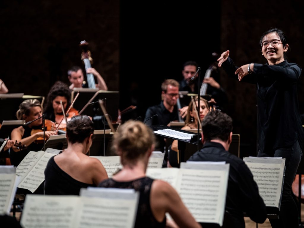 Chinese conductor Jiajing Lai performs in the first edition of La Maestra, an international competition for women conductors, held at the Philharmonie de Paris this September. CREDIT: Martin Bureau/AFP via Getty Images