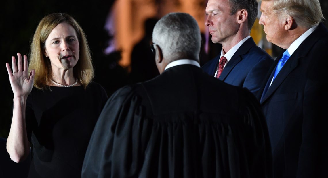President Trump watches as Supreme Court Justice Clarence Thomas administers the constitutional oath to Amy Coney Barrett during a ceremony at the White House Monday evening. CREDIT: Nicholas Kamm/AFP via Getty Images