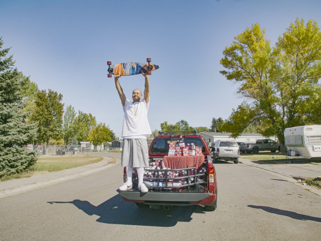 Nathan Apodaca's TikTok video, in which he longboards to Fleetwood Mac's "Dreams," has catapulted him to viral fame. Here, he is standing in the pickup truck given to him by Ocean Spray. In his video, Apodaca sips from a bottle of Ocean Spray's Cran-Raspberry juice. CREDIT: Ocean Spray