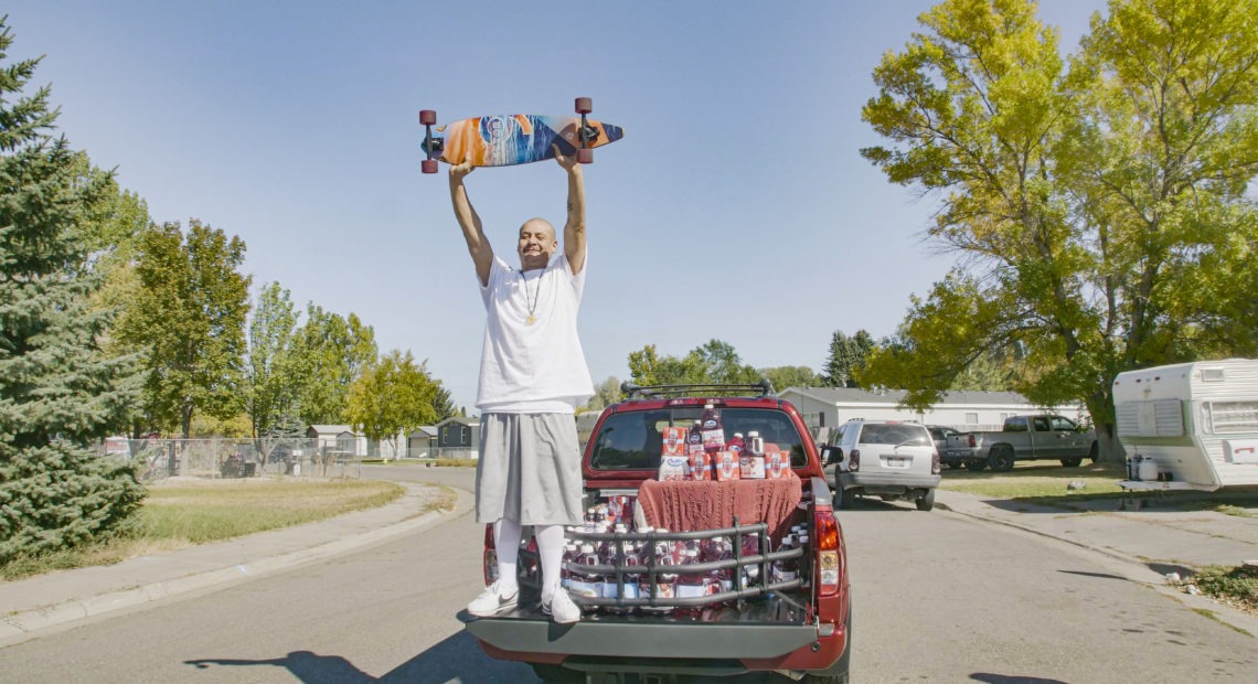 Nathan Apodaca's TikTok video, in which he longboards to Fleetwood Mac's "Dreams," has catapulted him to viral fame. Here, he is standing in the pickup truck given to him by Ocean Spray. In his video, Apodaca sips from a bottle of Ocean Spray's Cran-Raspberry juice. CREDIT: Ocean Spray