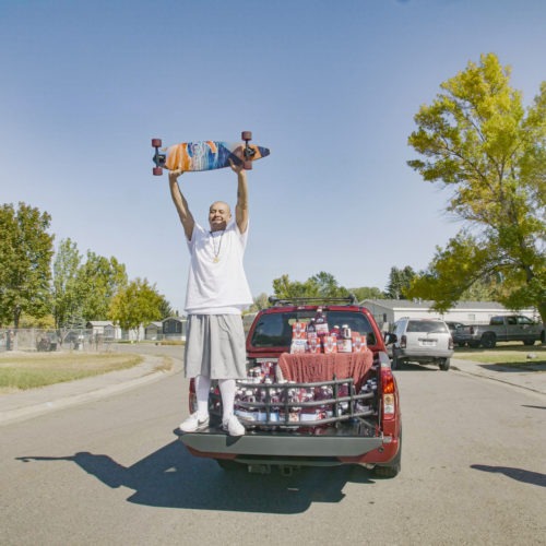 Nathan Apodaca's TikTok video, in which he longboards to Fleetwood Mac's "Dreams," has catapulted him to viral fame. Here, he is standing in the pickup truck given to him by Ocean Spray. In his video, Apodaca sips from a bottle of Ocean Spray's Cran-Raspberry juice. CREDIT: Ocean Spray