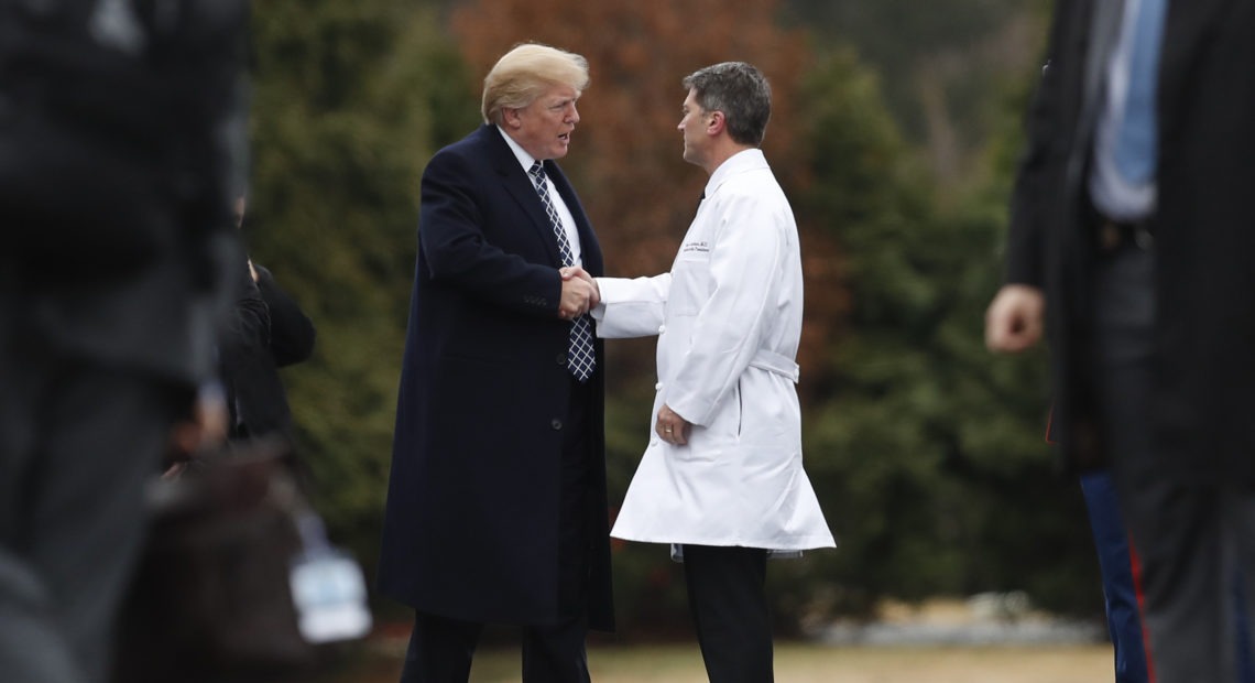 President Trump shakes hands with now-former White House physician Dr. Ronny Jackson in January 2018 following his first medical checkup as president. Carolyn Kaster/AP