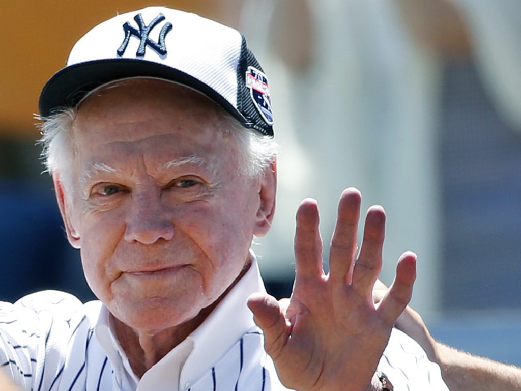 Former New York Yankees pitcher Whitey Ford, shown here waving to fans in 2016, has died at the age of 91. Kathy Willens/AP