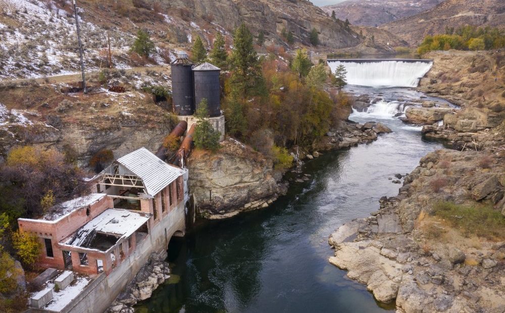 Enloe Dam powerhouse and dam in the distance on Oct. 28, 2020, in Oroville, Wash. Leaders of the Confederated Tribes of the Colville Reservation have announced and effort to determine the feasibility and costs associated with removal of the dam that has not generated electricity since 1958. CREDIT: Steve Ringman/The Seattle Times via AP