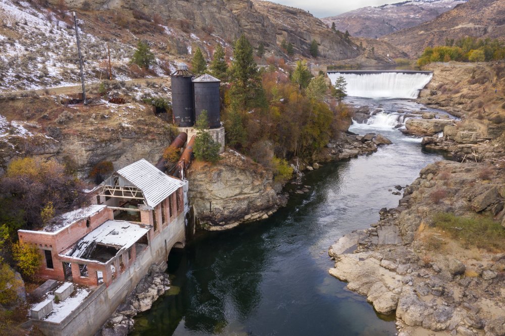 Enloe Dam powerhouse and dam in the distance on Oct. 28, 2020, in Oroville, Wash. Leaders of the Confederated Tribes of the Colville Reservation have announced and effort to determine the feasibility and costs associated with removal of the dam that has not generated electricity since 1958. CREDIT: Steve Ringman/The Seattle Times via AP