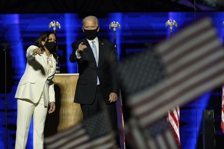 President-elect Joe Biden, right, on stage with Vice President-elect Kamala Harris, left, Saturday, Nov. 7, 2020, in Wilmington, Del. CREDIT: Andrew Harnik / AP