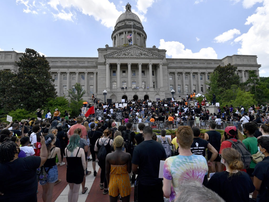 A crowd gathers for a rally to demand justice in the death of Breonna Taylor on the steps of the the Kentucky State Capitol in June. Taylor was killed in her apartment while Louisville police served a warrant. Timothy D. Easley/AP