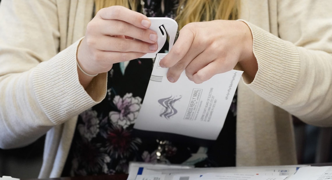 A Luzerne County worker canvases ballots that arrived after closing of voting until Friday at 5 p.m. and postmarked by Nov. 3rd as vote counting in the general election continues, Friday, Nov. 6, 2020, in Wilkes-Barre, Pa. (AP Photo/Mary Altaffer)