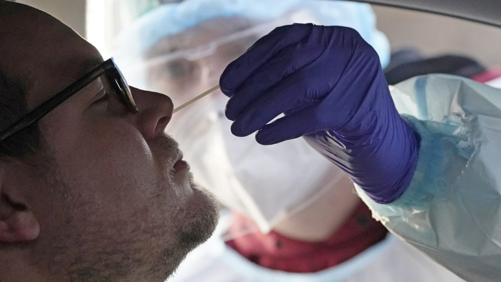 A coronavirus test is administered in Salt Lake City in Tuesday. At-home coronavirus tests will offer faster results than the traditional tests. CREDIT: Rick Bowmer/AP