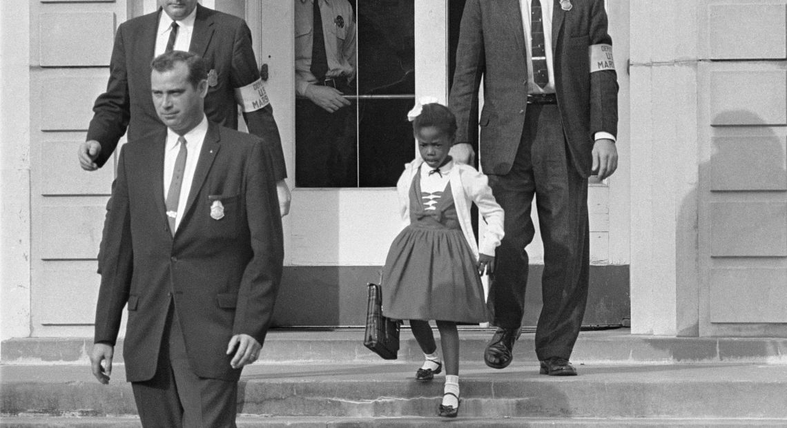 U.S. Deputy Marshals escort 6-year-old Ruby Bridges from William Frantz Elementary School in New Orleans, in this November 1960, file photo. Lucille Bridges, Ruby's mother, died Tuesday at the age of 86. Uncredited/AP