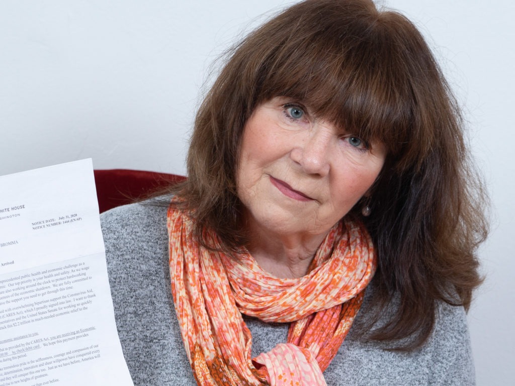Susanne Wigforss, a Swedish citizen, poses with the letter she received from the White House about the $1,200 economic impact payment she received.