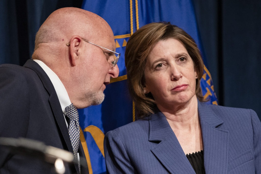 CDC Director Robert Redfield confers with Nancy Messonnier, director of the CDC's National Center for Immunization and Respiratory Diseases, during a Jan. 28 press conference in Washington, D.C., on the public health response to the coronavirus. CREDIT: Samuel Corum/Getty Images