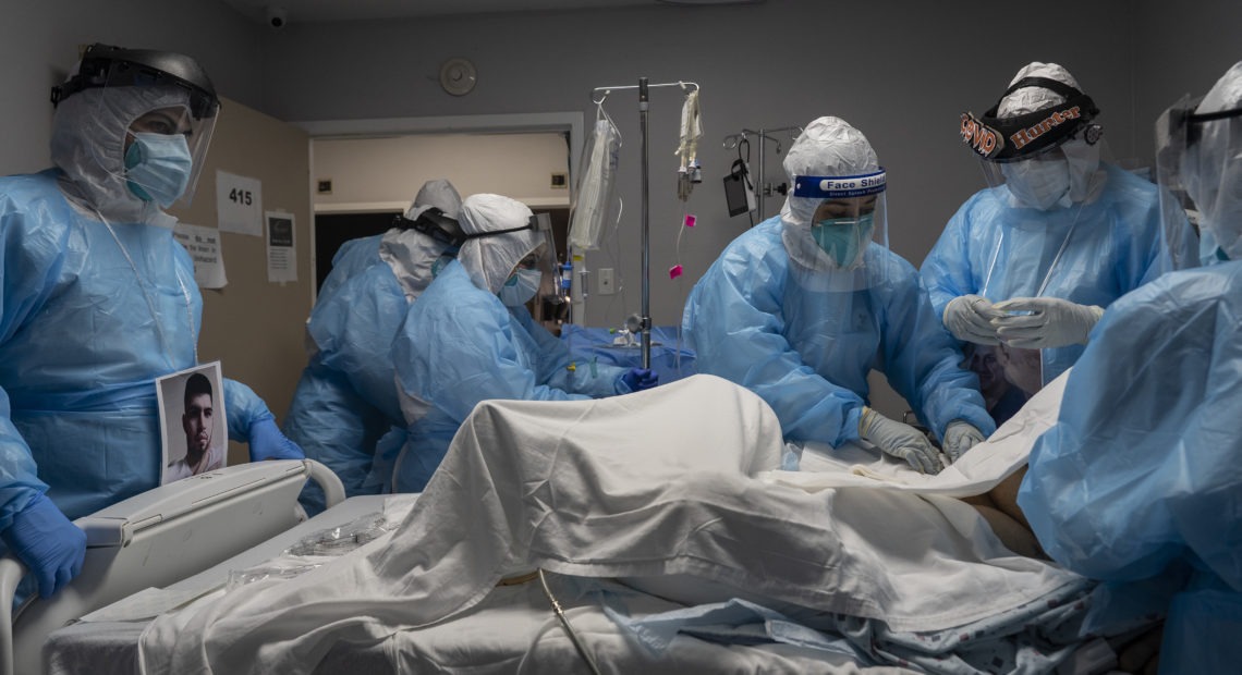 Medical staff members treat a patient seriously ill with COVID-19 in the intensive care unit of United Memorial Medical Center on Oct. 31 in Houston. Experts say immunizing health workers first, once a COVID-19 vaccine's available, is best to curb deaths and stop transmission. CREDIT: Go Nakamura/Getty Images