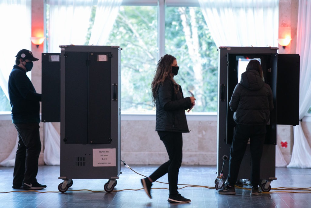 Voters cast ballots at the Park Tavern polling station on Tuesday in Atlanta. Nearly 95% of Georgia's estimated ballots have been reported, but metro Atlanta is currently the holdout area. CREDIT: Jessica McGowan/Getty Images