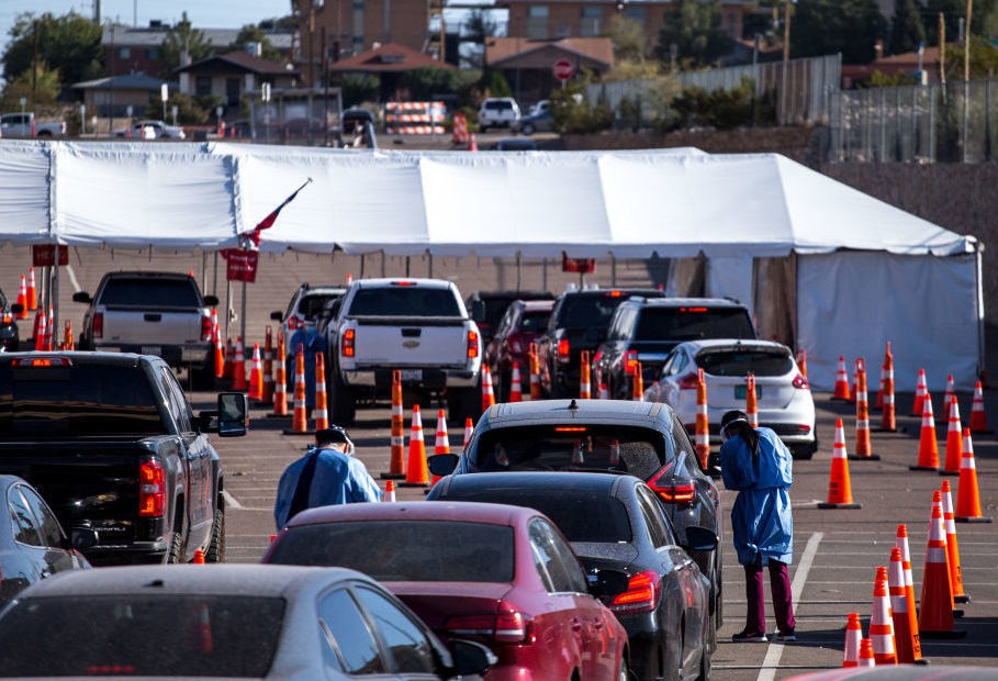 Medical workers wearing personal protective equipment register people in vehicles at a drive-through coronavirus testing site Monday in El Paso, Texas. Joel Angel Juarez/Bloomberg via Getty Images