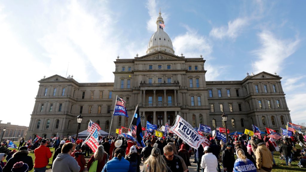 Protesters gather in support of President Trump on Nov. 14 at the Michigan Capitol in Lansing. Trump and his allies have baselessly alleged widespread voter fraud was to blame for the president's election loss. CREDIT: Jeff Kowalsky/AFP via Getty Images
