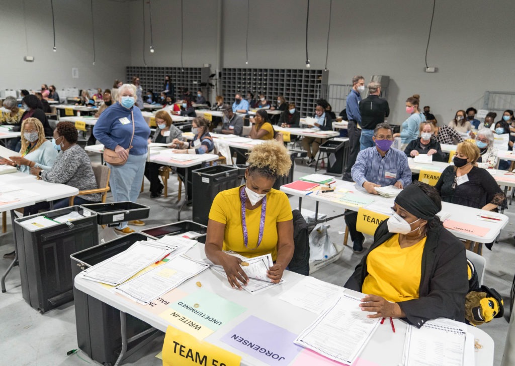 Gwinnett County election workers handle ballots Monday in Lawrenceville, Ga., as part of the state's recount for the 2020 presidential election. CREDIT: Megan Varner/Getty Images