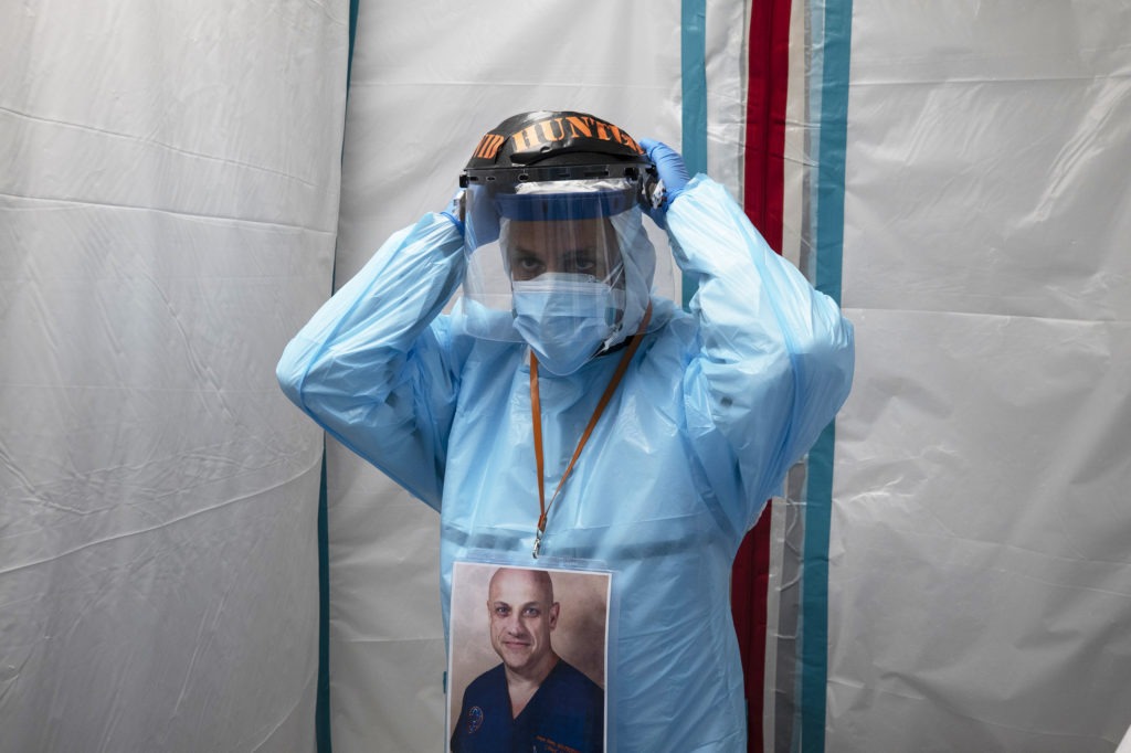 Dr. Joseph Varon puts on his face shield before entering the COVID-19 intensive care unit at United Memorial Medical Center on Monday in Houston. Texas has recorded more than 1.1 million cases of the virus, with more than 20,000 deaths. Go Nakamura/Getty Images