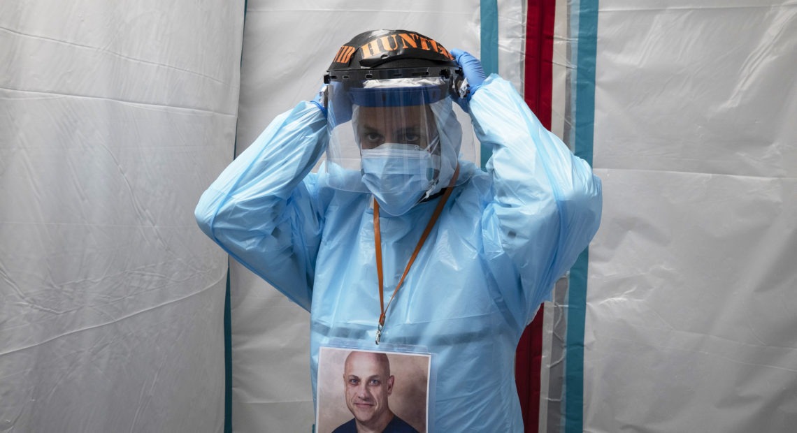 Dr. Joseph Varon puts on his face shield before entering the COVID-19 intensive care unit at United Memorial Medical Center on Monday in Houston. Texas has recorded more than 1.1 million cases of the virus, with more than 20,000 deaths. Go Nakamura/Getty Images