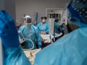 Medical staff prepare for an intubation procedure on a COVID-19 patient in a Houston intensive care unit. In some parts of the U.S., as hospitals get crowded, hospital leaders are worried they may need to implement crisis standards of care. Go Nakamura/Getty Images