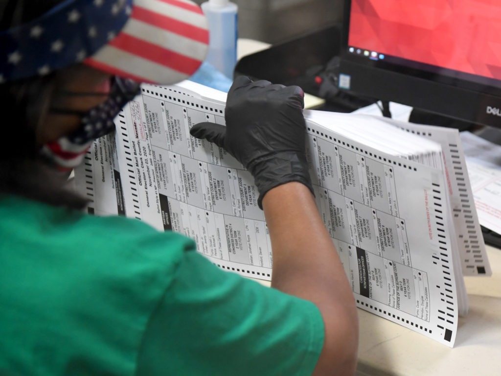 A Clark County election worker scans mail-in ballots on Nov. 7 in North Las Vegas, Nevada. CREDIT: Ethan Miller/Getty Images