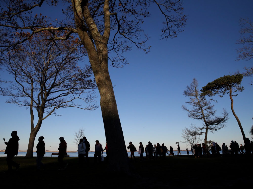 Marchers perform a Stomp Dance in Pilgrim Memorial State Park during the 48th National Day of Mourning in Plymouth, Mass., on Nov 23, 2017. Since 1970, Indigenous people have gathered at noon on Cole's Hill in Plymouth to commemorate a National Day of Mourning on Thanksgiving. Boston Globe/Boston Globe via Getty Images