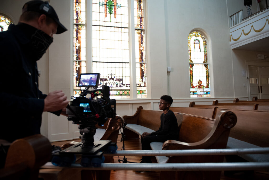 Sean Patrick Kirby, director of photography, prepares the opening scene with Jaxon Moore. CREDIT: Andi Rice