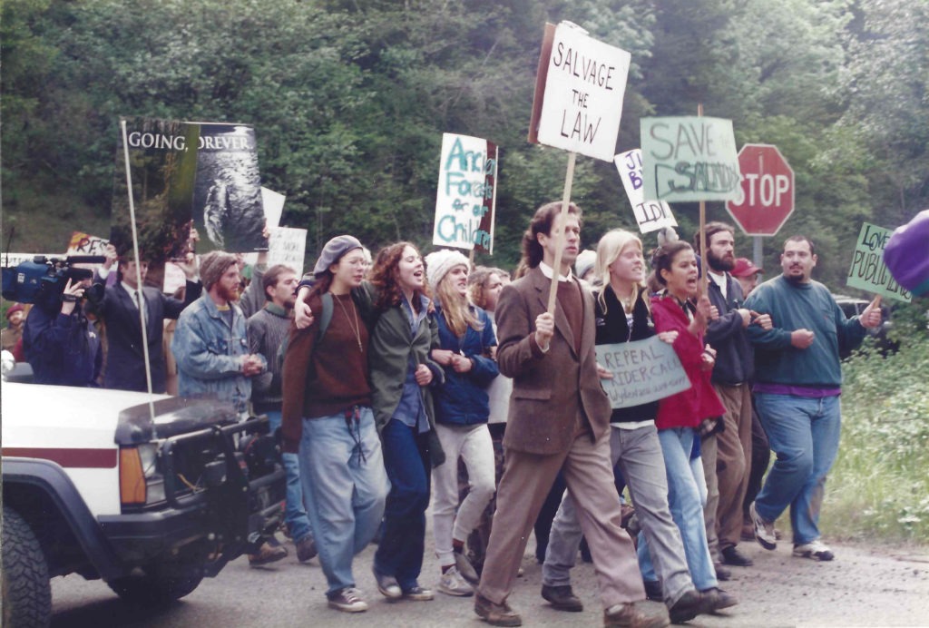 Activists march in protest of the 