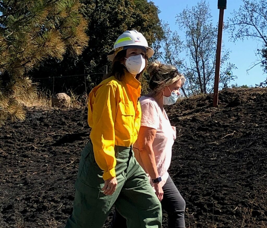 Washington Lands Commissioner Hilary Franz, walking here with former Malden Mayor Chris Ferrell, is working with legislators to find more money for wildfire suppression and prevention. CREDIT: Doug Nadvornick/SPR