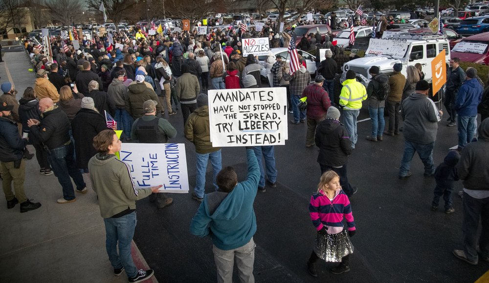 Anti-masker demonstrators converge on Central District Health offices, Tuesday, Dec. 8, 2020 in Boise, Idaho, to the protest a meeting deciding on more mandates to combat the spread of COVID-19. CREDIT: Darin Oswald/Idaho Statesman via AP
