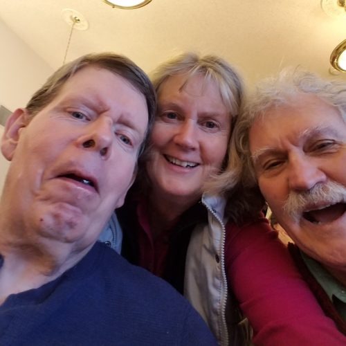 Ken Roberts, left, with his step-sister Debbie Roberts and her husband Steve Kinzie at a Christmas gathering at the Tonasket care facility in 2018. Courtesy of Debbie Roberts