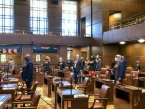 Oregon senators convene at the Capitol on Monday, Dec. 21, 2020 during a one-day special session to address specific COVID-19 relief issues. Protesters against coronavirus safety measures broke doors and tried to force their way inside. CREDIT: Dirk VanderHart/OPB