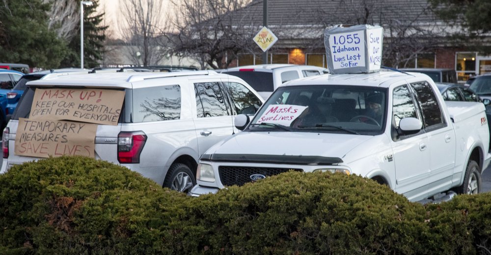 Supporters of health workers and mask mandates held a silent counter protest by decorating their vehicles at an anti-mask protest at the Central District Health offices, Tuesday, Dec. 8, 2020 in Boise, Idaho. CREDIT: Darin Oswald/Idaho Statesman via AP