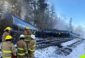 Fire crews respond to the scene of a derailed train in the city of Custer, Washington, in Whatcom County on Tuesday, December 22, 2020. A BNSF spokesperson said seven train cars derailed and two caught fire. CREDIT: Washington Dept. of Ecology