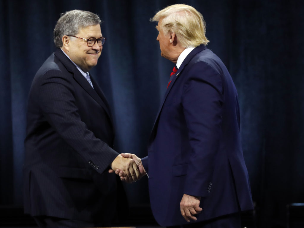 President Donald Trump greeted Attorney General William Barr before Trump signed an executive order creating a commission to study law enforcement and justice on Oct. 28, 2019. CREDIT: Charles Rex Arbogast/AP