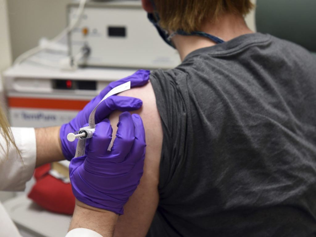 Administering COVID-19 vaccine during trial of the Pfizer covid trial.