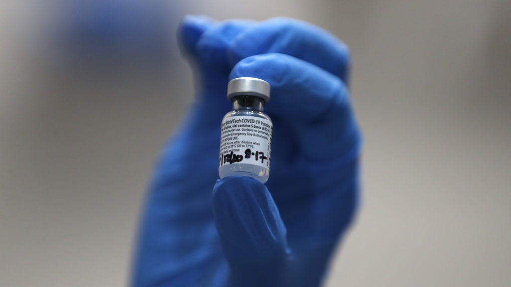 A nurse holds a vial of the COVID-19 vaccine produced by Pfizer and BioNTech, in London earlier this week. Food and Drug Administration officials in the U.S. sought to reassure the public about the vaccine Saturday after authorizing it for emergency use. Frank Augstein/AP