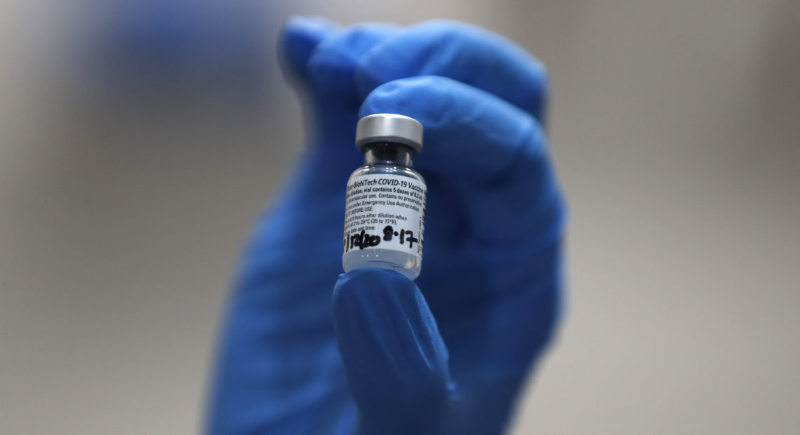 A nurse holds a vial of the COVID-19 vaccine produced by Pfizer and BioNTech, in London earlier this week. Food and Drug Administration officials in the U.S. sought to reassure the public about the vaccine Saturday after authorizing it for emergency use. Frank Augstein/AP