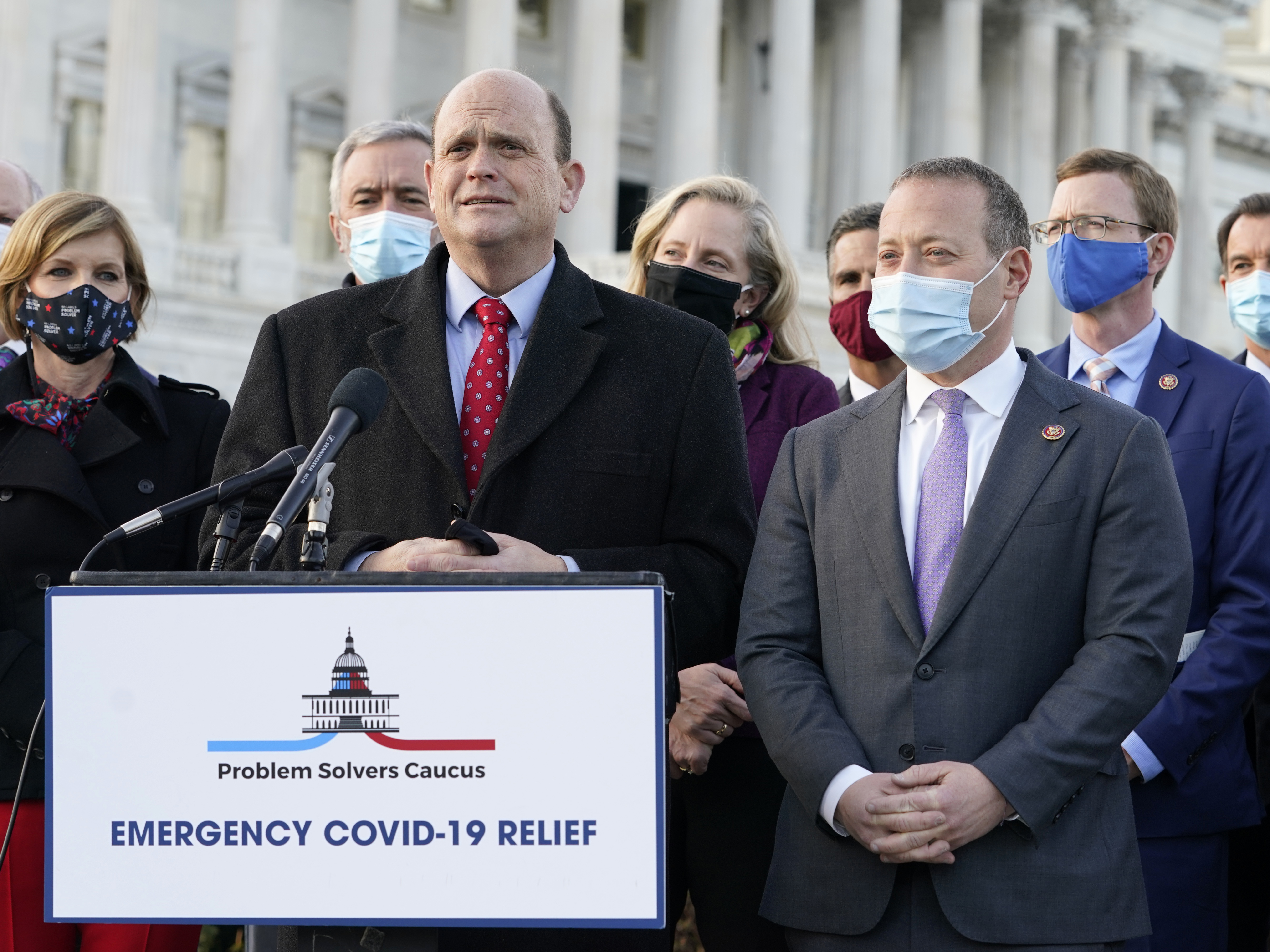 Members of the bipartisan Problem Solvers Caucus — co-chairs Rep. Tom Reed, R-N.Y., at podium, and Rep. Josh Gottheimer, D-N.J., right — took credit for helping to break the logjam on an emergency COVID-19 relief bill. CREDIT: Jacquelyn Martin/AP