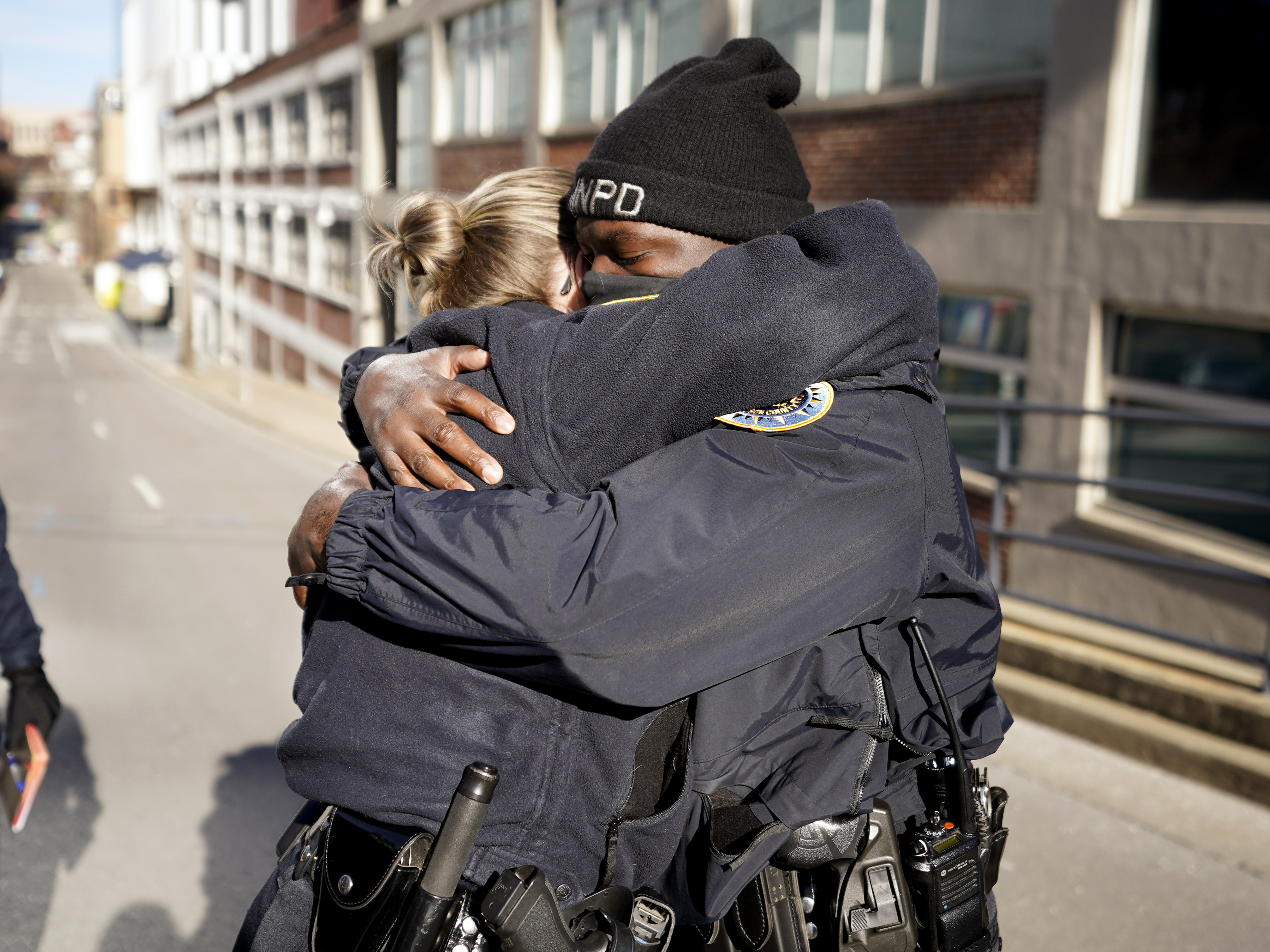 Nashville, Tenn., police officers Brenna Hosey and James Wells embrace after speaking at a news conference on Sunday. Hosey and Wells are part of a group of officers credited with evacuating people before the explosion that occurred in downtown Nashville early Christmas morning. CREDIT: Mark Humphrey/AP