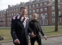 Love Story stars Ryan O'Neal and Ali MacGraw walk on the campus of Harvard University in Cambridge, Mass., in February 2016. CREDIT: Elise Amendola/AP