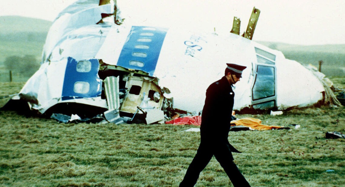 A police officer walks on Dec. 21, 1988, by the nose of Pan Am Flight 103 near Lockerbie, Scotland, where it lay after a bomb aboard exploded, killing a total of 270 people. CREDIT: Martin Cleaver/AP