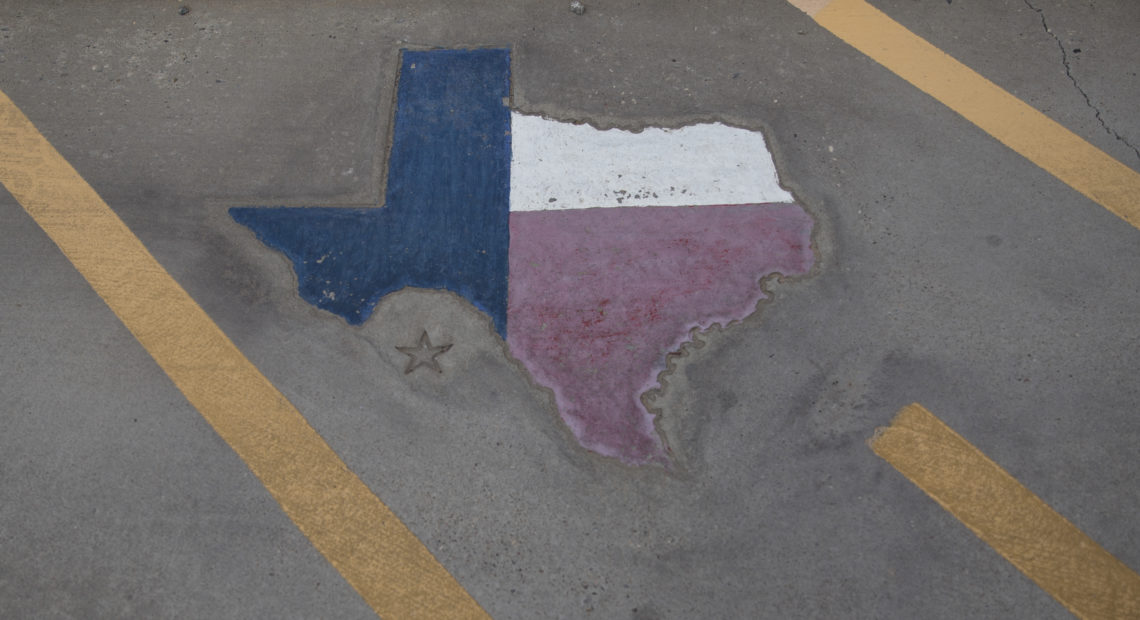 Texas is displayed on a parking spot at the Old Glory Memorial in El Paso, Texas. CREDIT: Adria Malcolm/Bloomberg via Getty Images