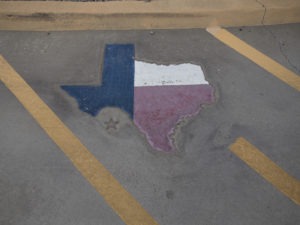Texas is displayed on a parking spot at the Old Glory Memorial in El Paso, Texas. CREDIT: Adria Malcolm/Bloomberg via Getty Images