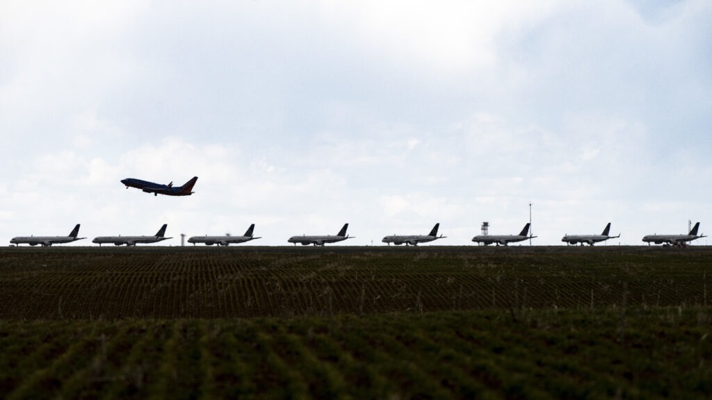 A Southwest Airlines flight takes off as United Airlines planes sit parked on a runway at Denver International Airport in April. CREDIT: Michael Ciaglo/Getty Images