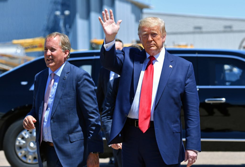 Texas Attorney General Ken Paxton, seen here with President Trump in June in Dallas, sued four states that Joe Biden carried in the general election, claiming their changes to election procedures during the pandemic violated federal law. CREDIT: Nicholas Kamm/AFP via Getty Images