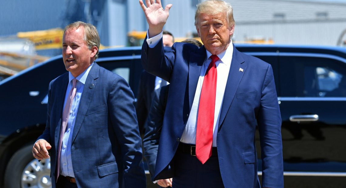 Texas Attorney General Ken Paxton, seen here with President Trump in June in Dallas, sued four states that Joe Biden carried in the general election, claiming their changes to election procedures during the pandemic violated federal law. CREDIT: Nicholas Kamm/AFP via Getty Images