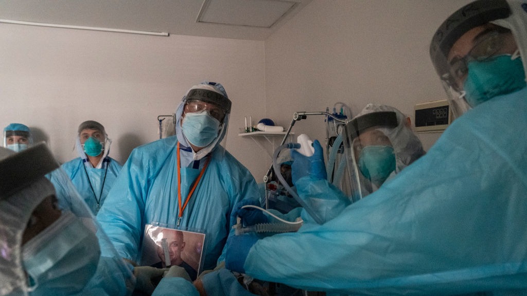 Health care workers in Houston, Texas, perform a procedure on a patient in the COVID-19 intensive care unit on Thanksgiving. This past week has seen continued steep growth in cases, hospitalizations and deaths from COVID-19. Go Nakamura/Getty Images